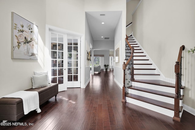 foyer featuring dark hardwood / wood-style flooring and french doors