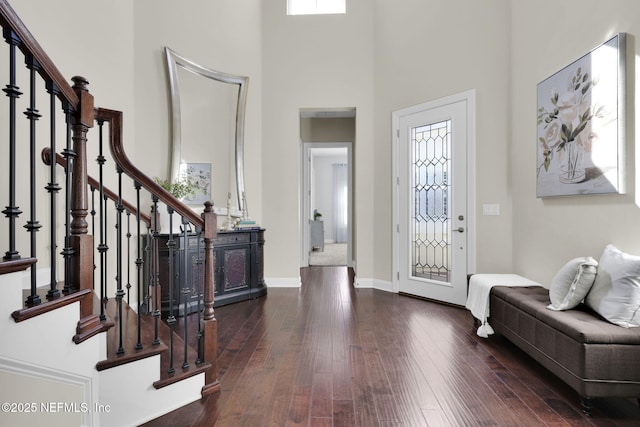 entryway with a high ceiling and dark hardwood / wood-style floors