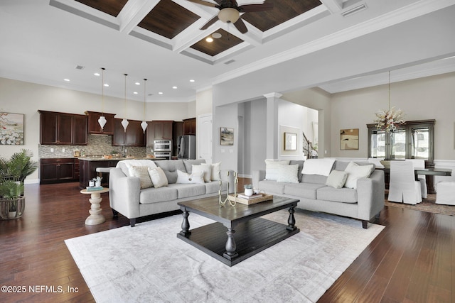 living room featuring coffered ceiling, dark hardwood / wood-style flooring, beam ceiling, and a high ceiling