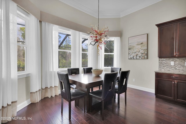 dining room featuring crown molding, dark hardwood / wood-style floors, and a notable chandelier