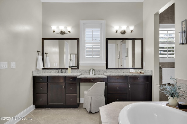 bathroom with vanity, a relaxing tiled tub, and tile patterned floors