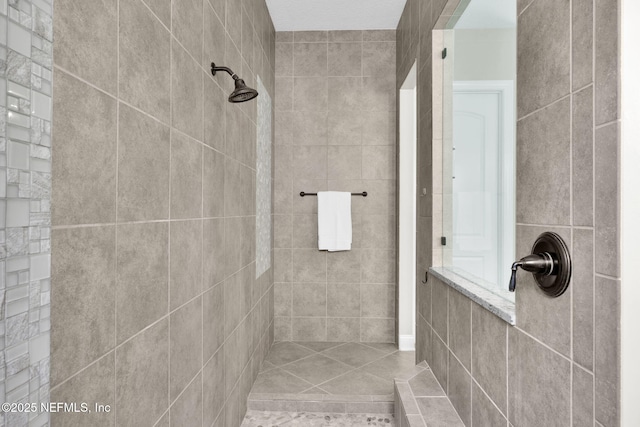 bathroom with tiled shower