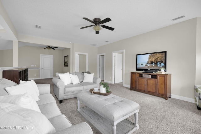 carpeted living room featuring ceiling fan