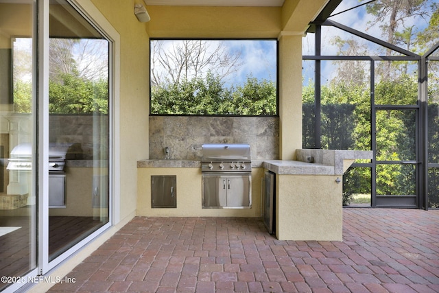 view of patio / terrace with area for grilling, grilling area, and a lanai