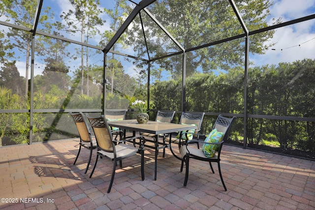 view of patio / terrace featuring glass enclosure