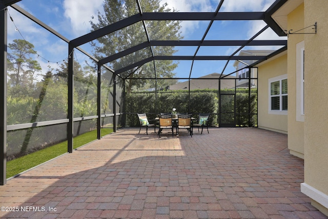 view of patio / terrace featuring a lanai