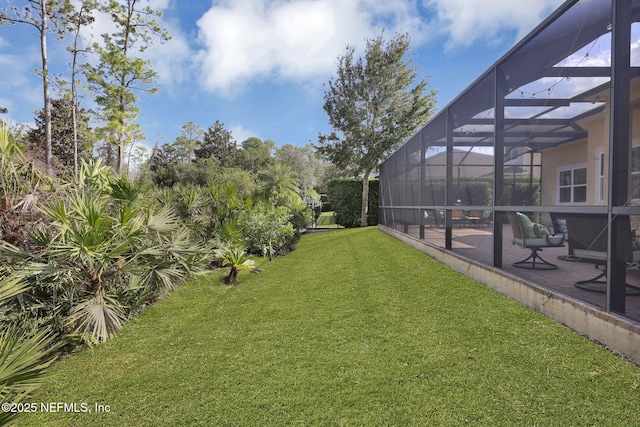 view of yard with a lanai and a patio area