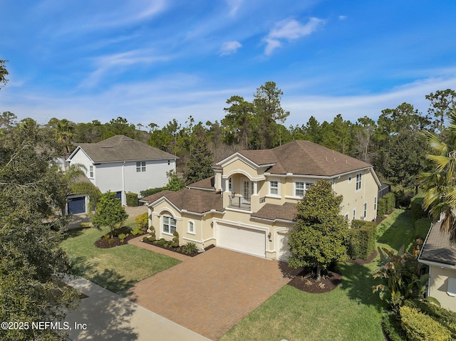 view of front of property with a garage and a front lawn