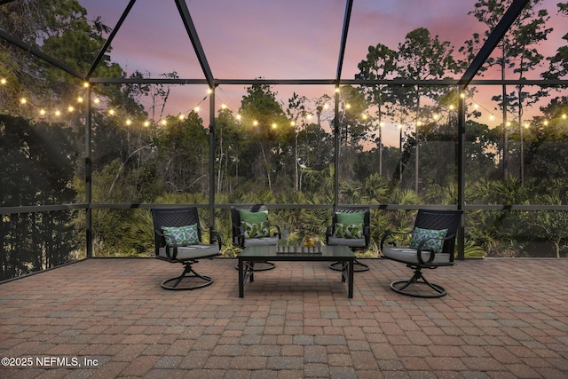 patio terrace at dusk featuring a lanai