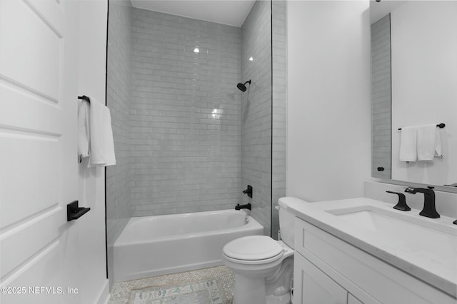 full bathroom with tiled shower / bath combo, vanity, tile patterned floors, and toilet