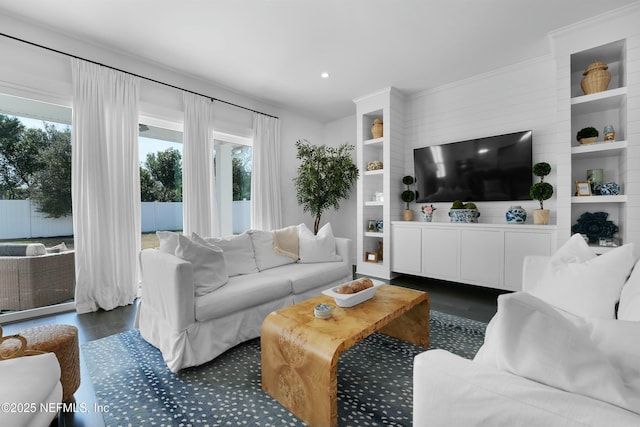 living room featuring dark hardwood / wood-style flooring and a healthy amount of sunlight