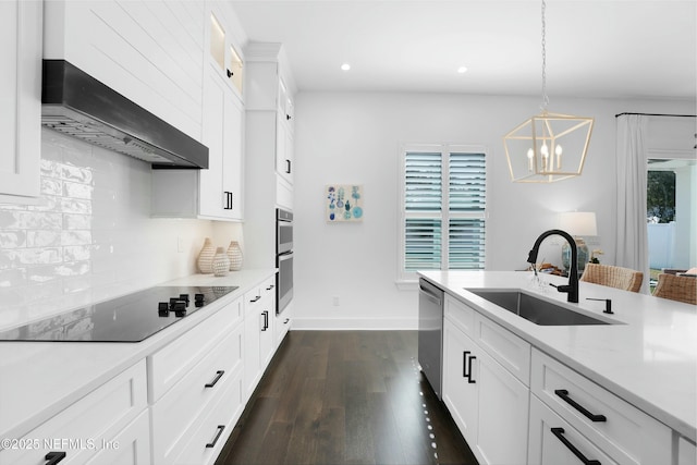 kitchen featuring stainless steel appliances, hanging light fixtures, sink, and white cabinets