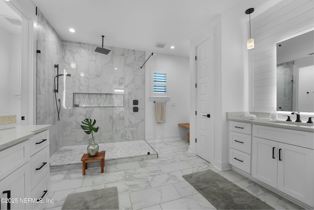 bathroom featuring vanity and tiled shower