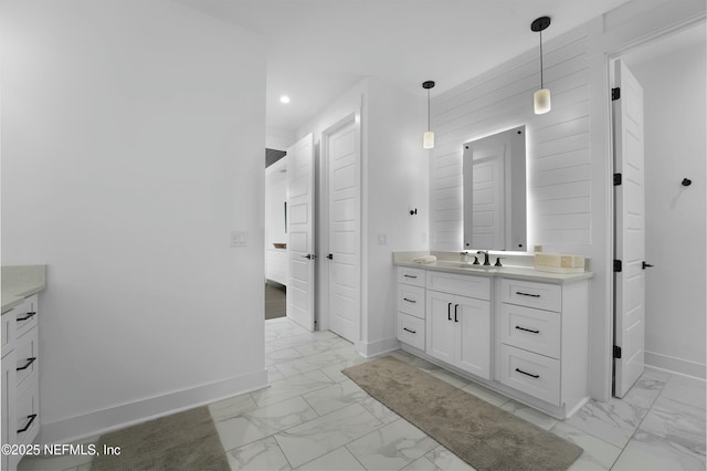 bathroom with vanity and wood walls