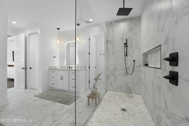 bathroom featuring vanity and a tile shower