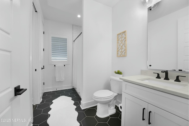 bathroom featuring tile patterned floors, vanity, and toilet