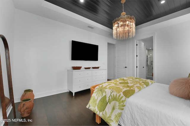 bedroom with dark hardwood / wood-style flooring, wood ceiling, a raised ceiling, and an inviting chandelier