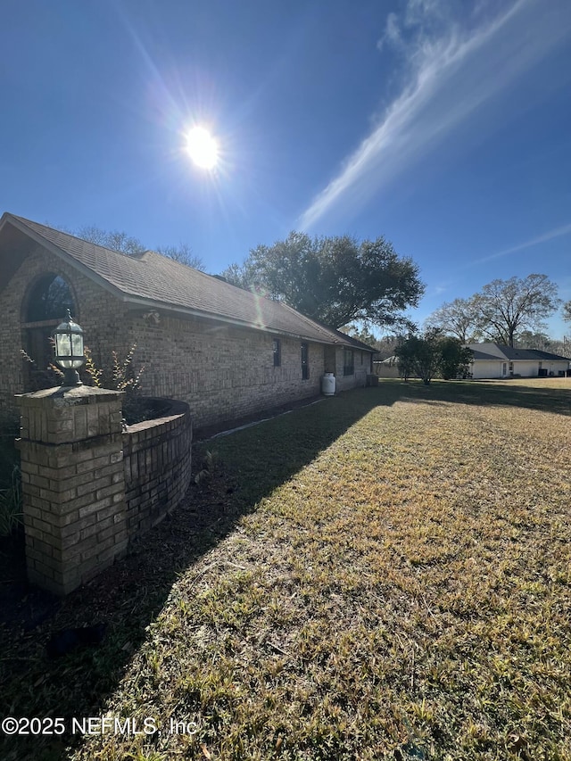 view of home's exterior with a lawn