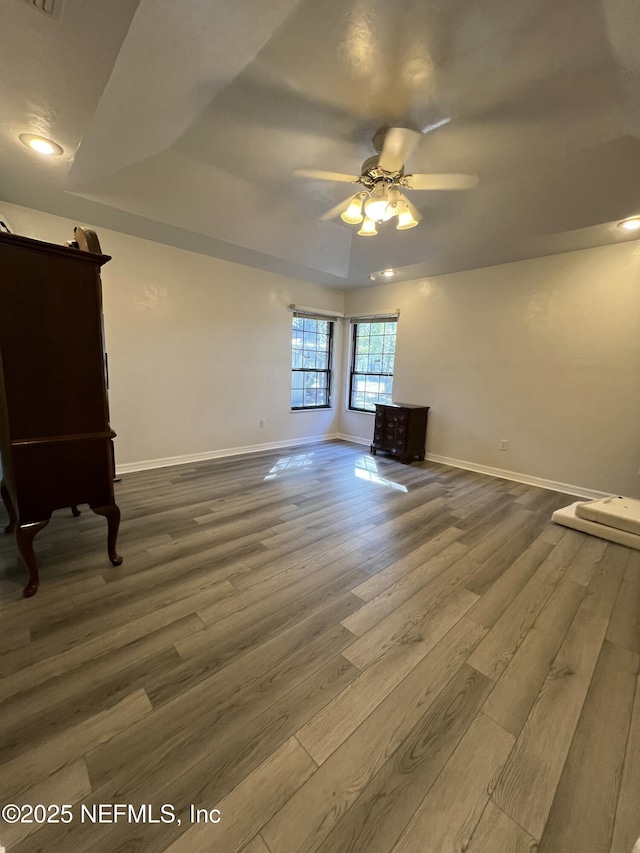 unfurnished living room featuring wood-type flooring and ceiling fan