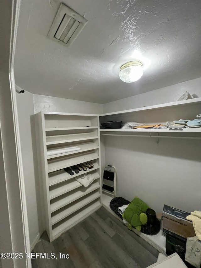 spacious closet featuring hardwood / wood-style floors