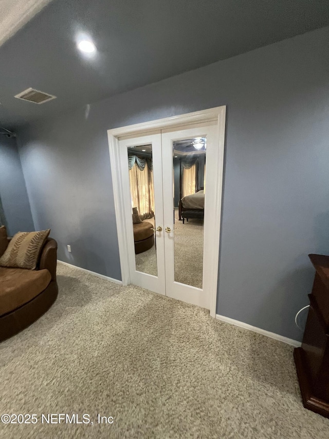 sitting room featuring carpet flooring and french doors