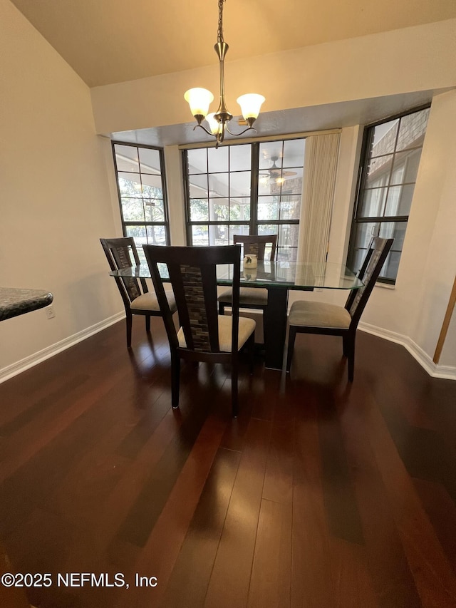 dining room featuring dark wood-type flooring and a chandelier