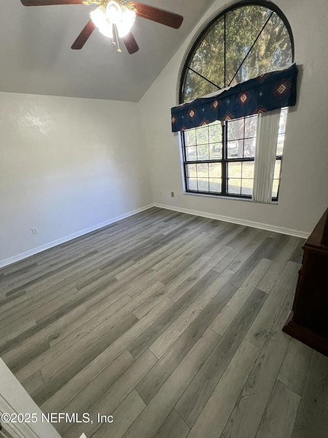 unfurnished living room with wood-type flooring, vaulted ceiling, and ceiling fan