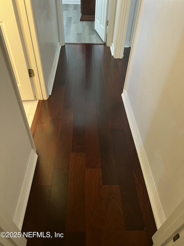 hall with dark hardwood / wood-style flooring