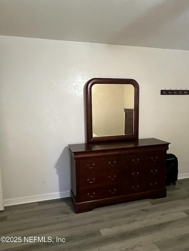 unfurnished bedroom with hardwood / wood-style floors