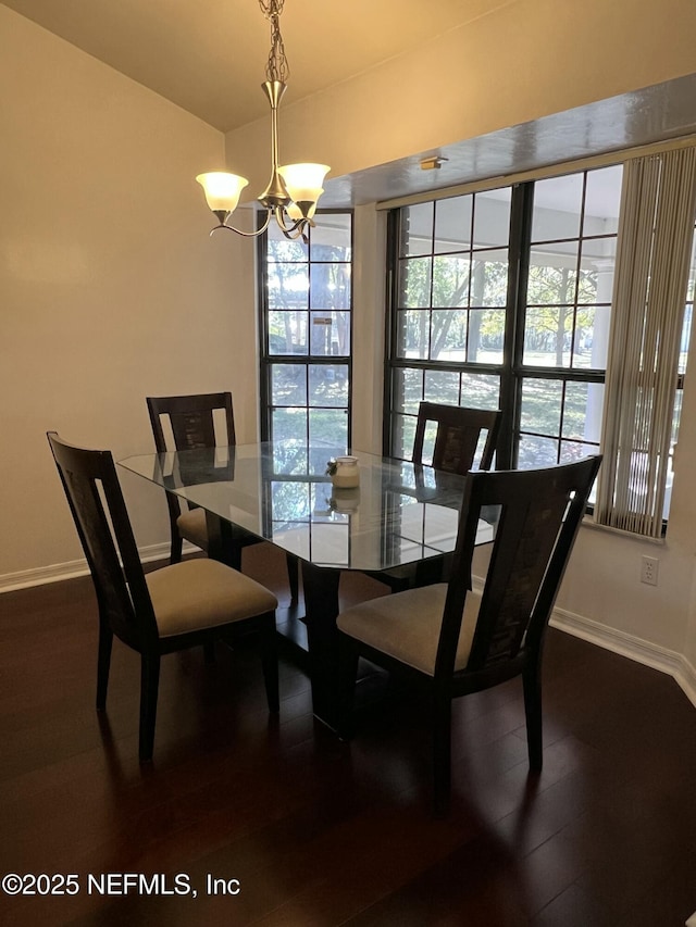 dining room featuring an inviting chandelier and dark hardwood / wood-style floors