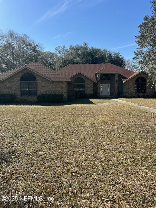 ranch-style house with a front lawn