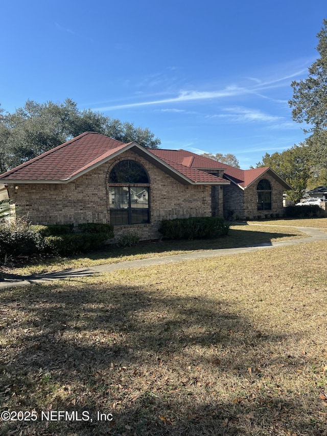 view of property exterior featuring a lawn