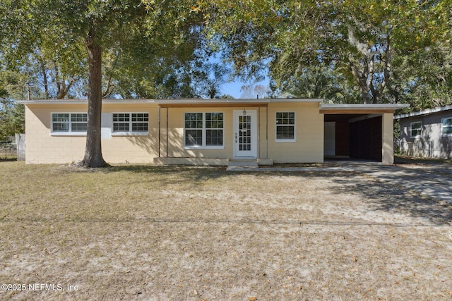 single story home featuring a front yard and a carport