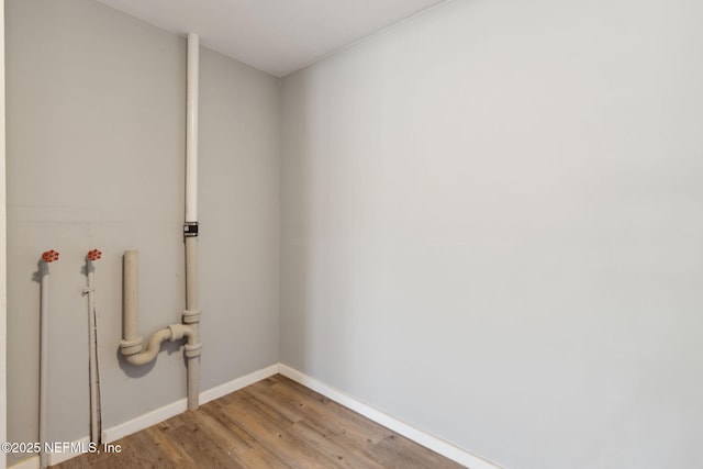 laundry room featuring light wood-type flooring