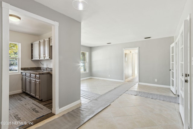 interior space with light tile patterned flooring and sink