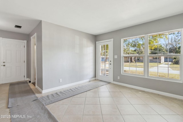 unfurnished room featuring light tile patterned floors