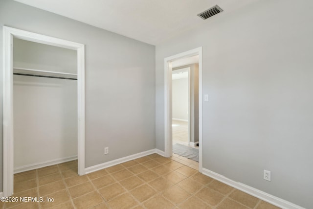 unfurnished bedroom with a closet