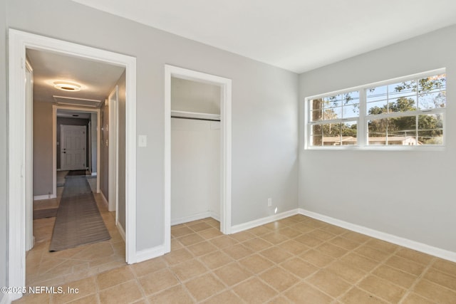 unfurnished bedroom featuring a closet and light tile patterned floors