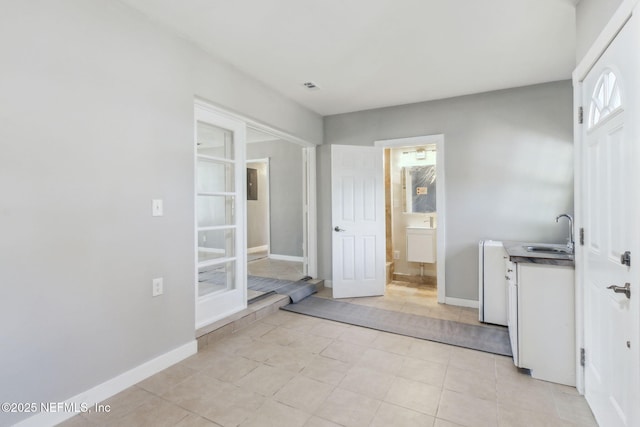 interior space featuring sink and light tile patterned floors