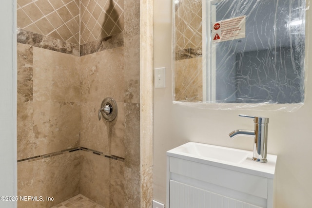 bathroom featuring vanity and a tile shower