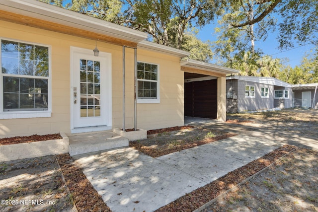 view of exterior entry with a garage