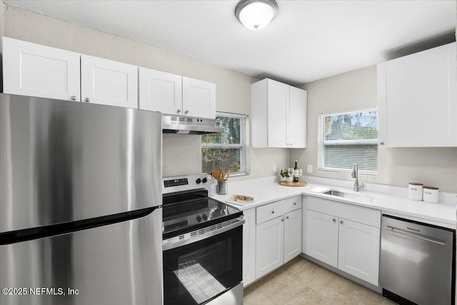 kitchen featuring a healthy amount of sunlight, sink, stainless steel appliances, and white cabinets