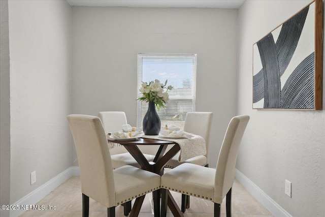 dining space featuring light tile patterned flooring