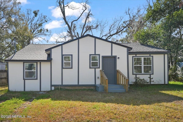 back of house featuring a lawn