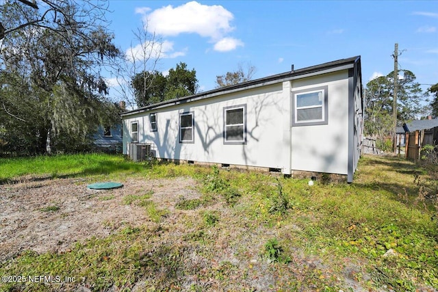 rear view of property with central AC unit