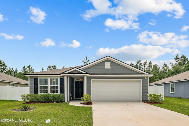 ranch-style home featuring a garage and a front yard