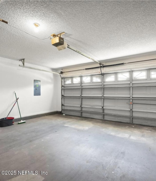 garage with a garage door opener and electric panel