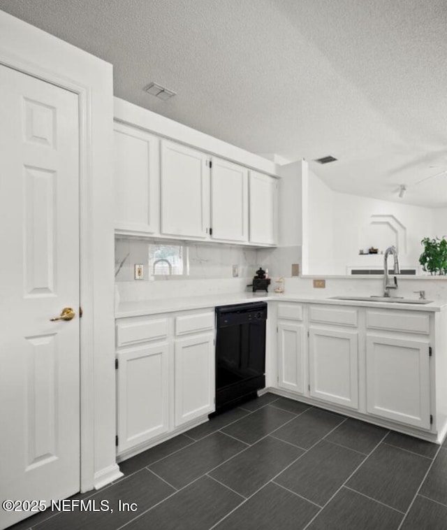 kitchen with black dishwasher, sink, and white cabinets