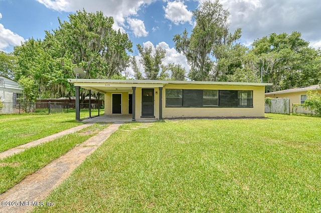 ranch-style house with a front lawn and a carport