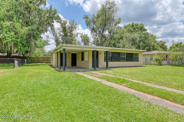 ranch-style house with a front lawn and a patio